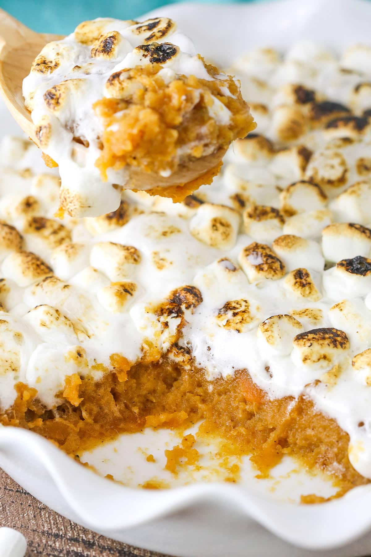 Sweet potato casserole in a baking dish with a scoop being taken out.