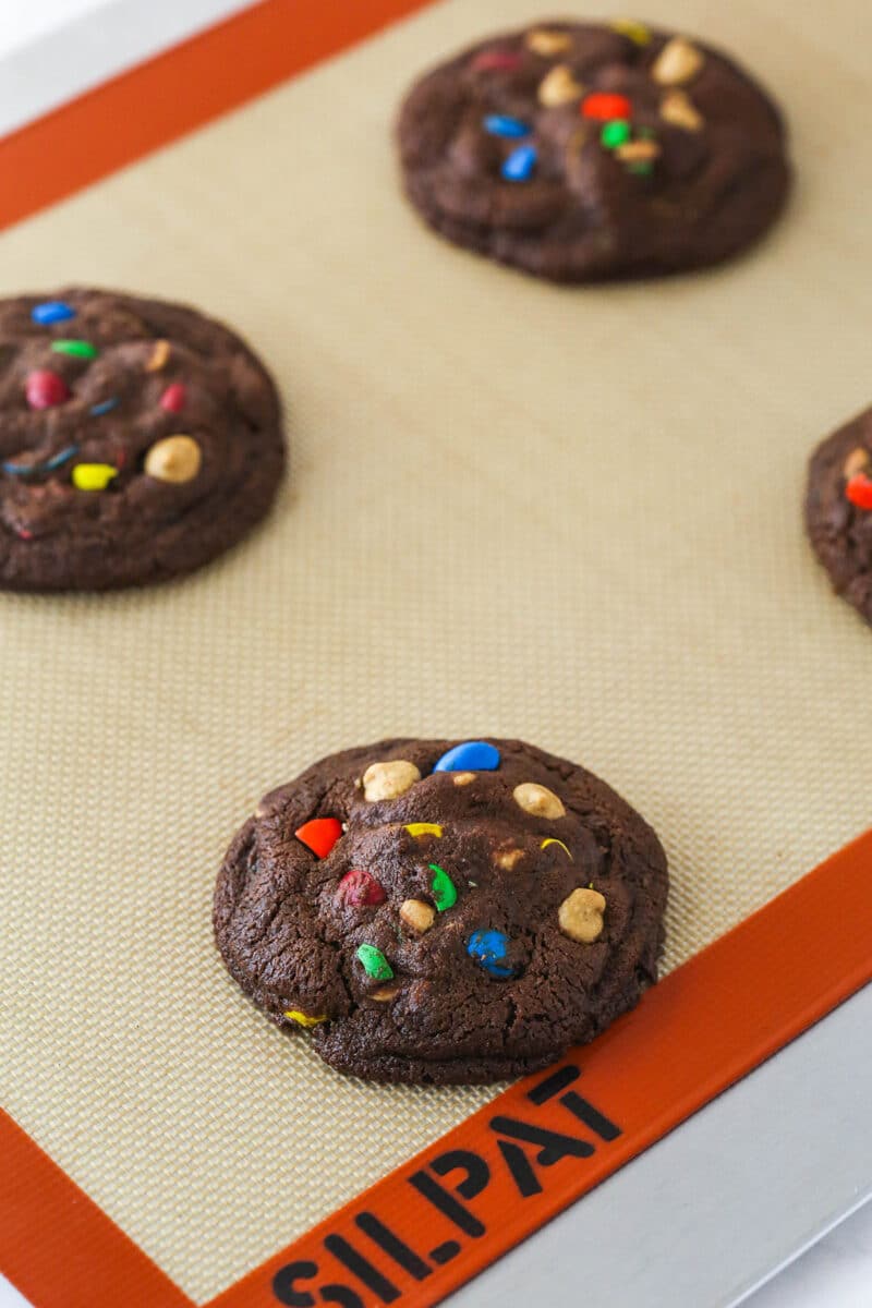 Peanut butter M&M chocolate cookies on a baking sheet