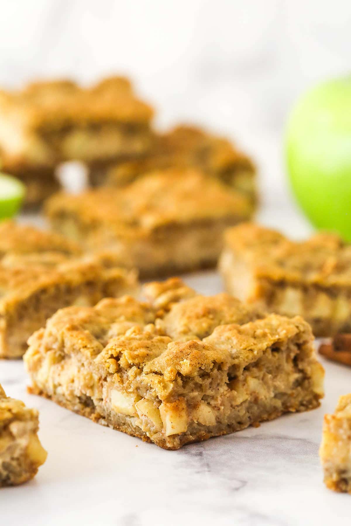 Apple cheesecake oatmeal cookie bars on a countertop