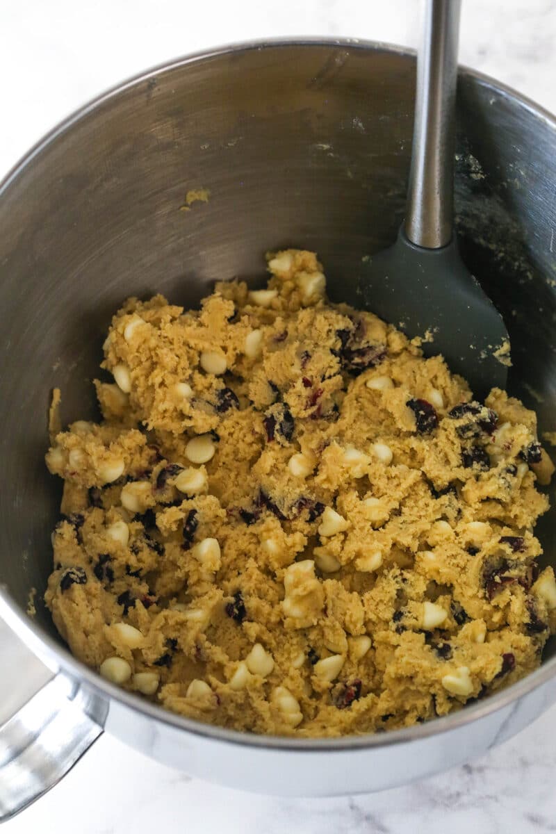 Mixing the cranberries and white chocolate chips into the cookie dough