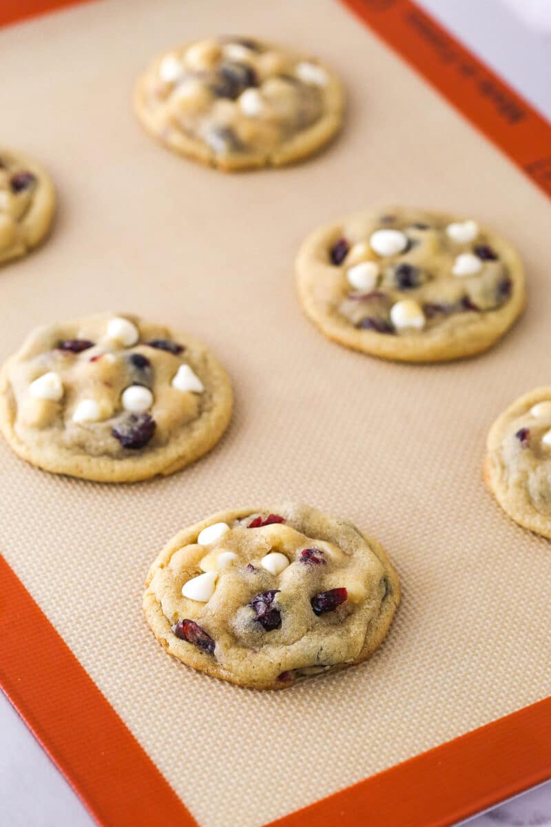 White chocolate chip cranberry cookies on a baking sheet