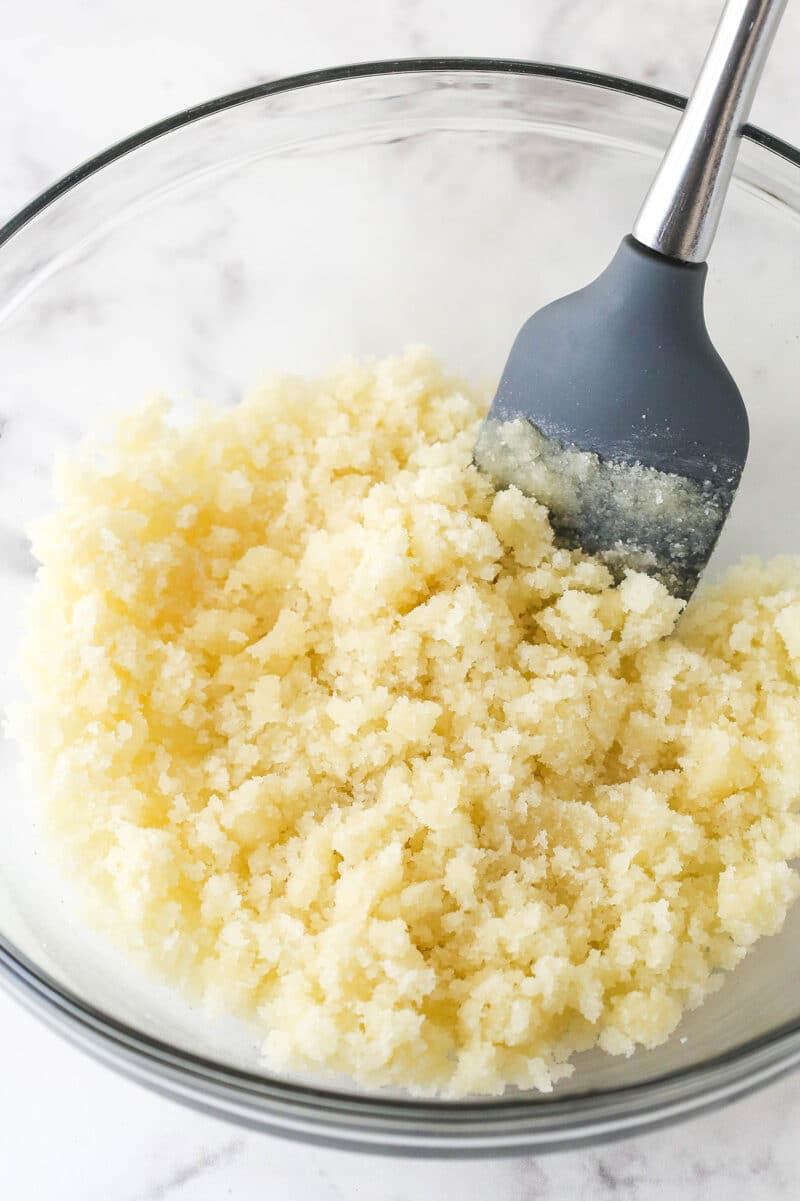 Sugar, flour, butter and vanilla extract combined in a glass bowl