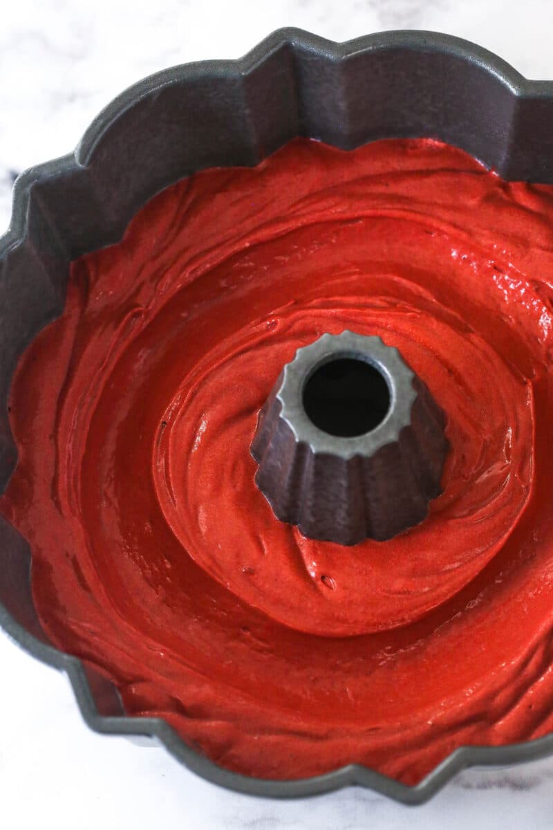 Red velvet cake batter in a bundt pan