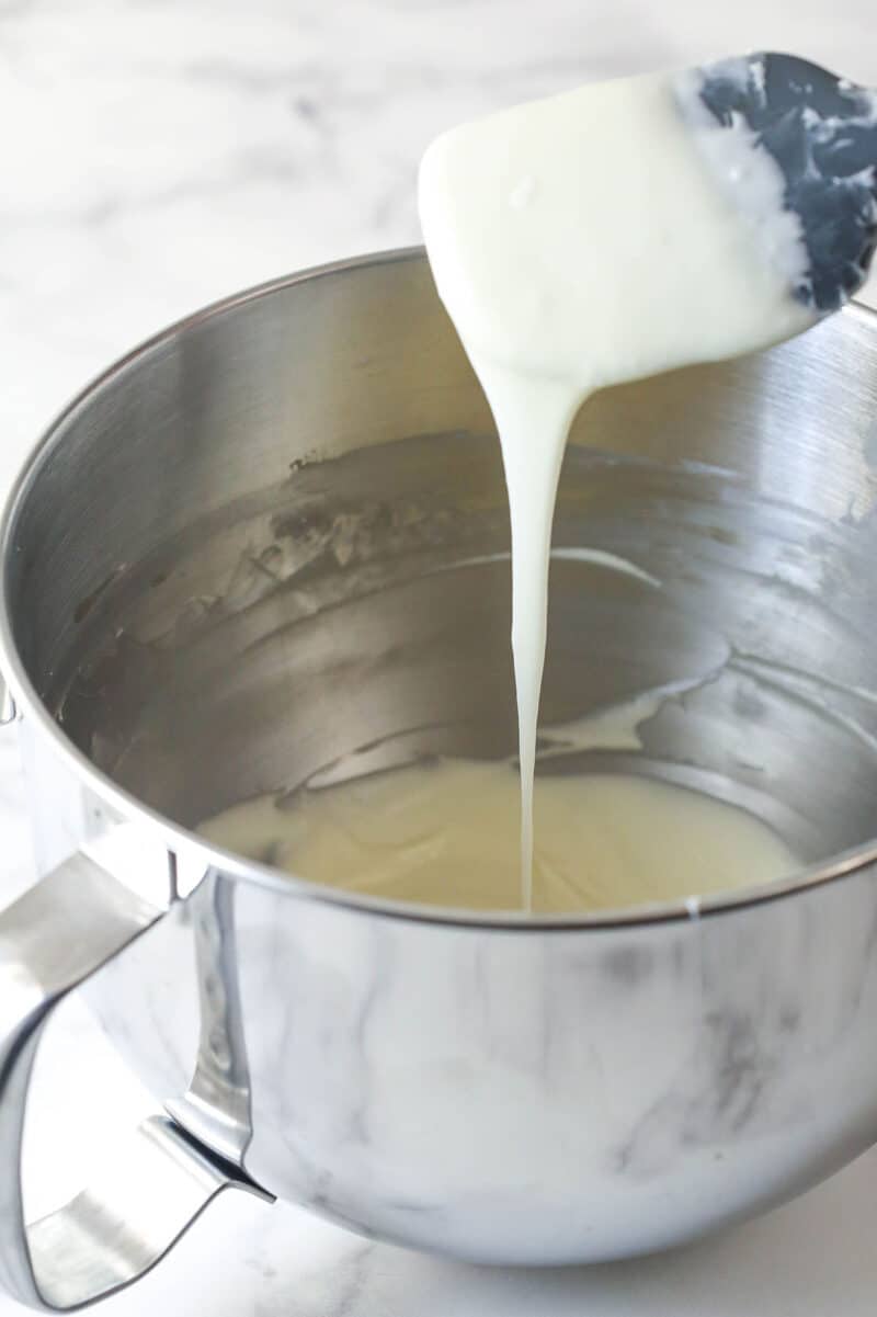 Cream cheese frosting dripping off a spatula