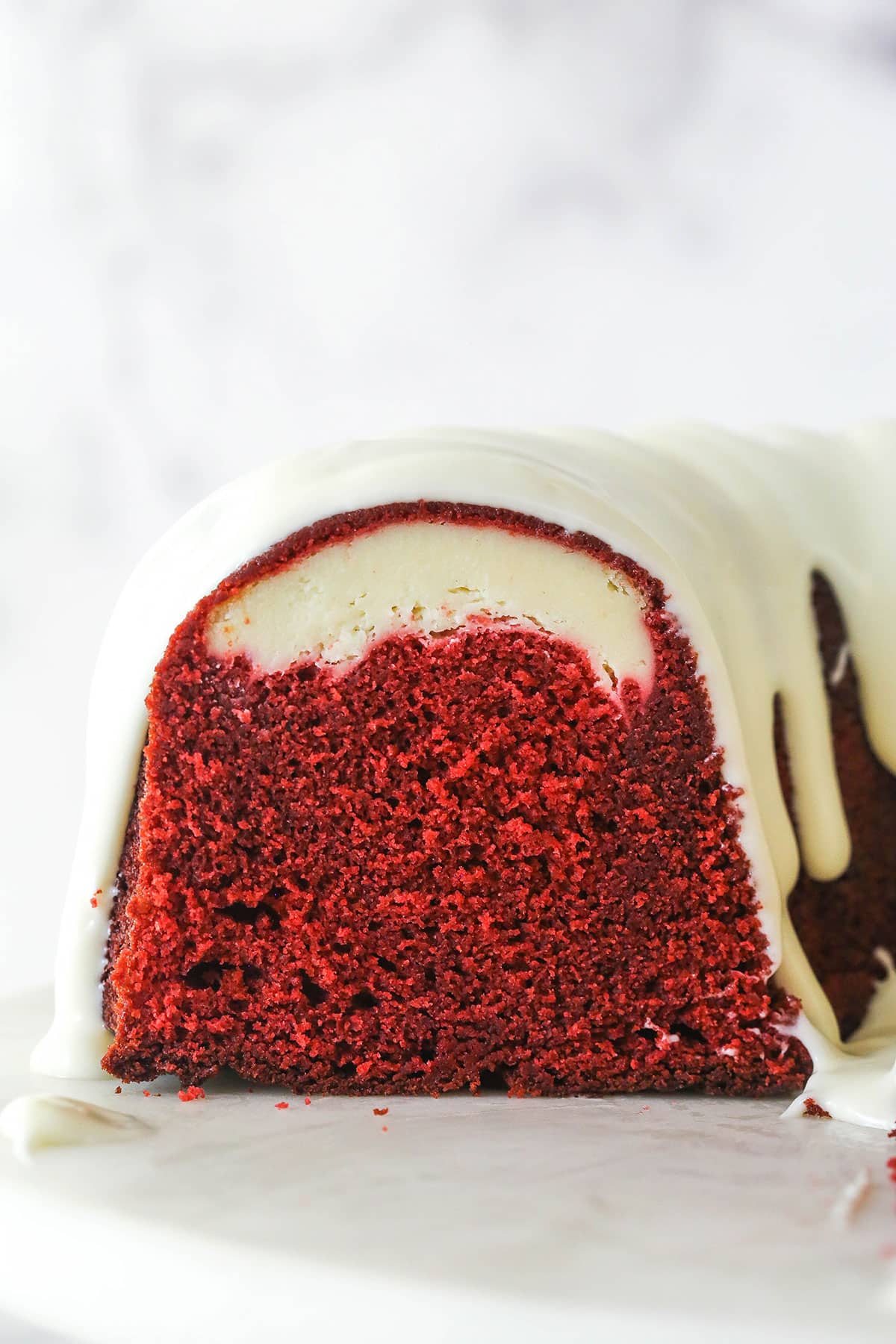 The end of a red velvet cheesecake swirl bundt cake