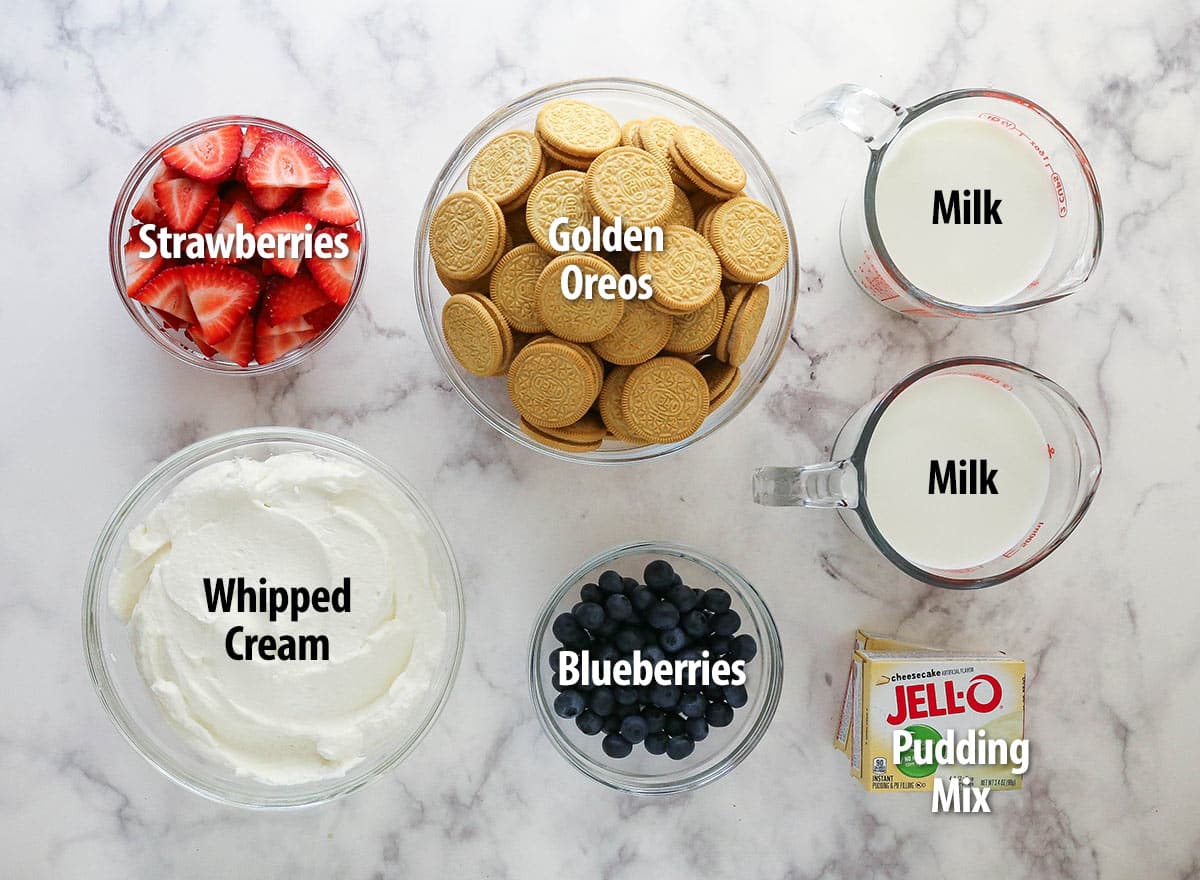 ingredients for mixed berry icebox cake on marble background