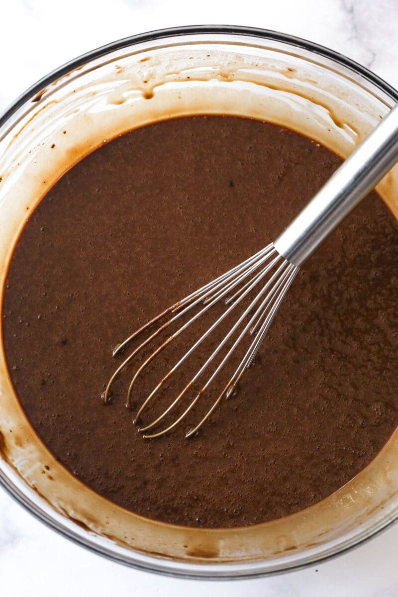 Whisking hot water into chocolate cupcake batter