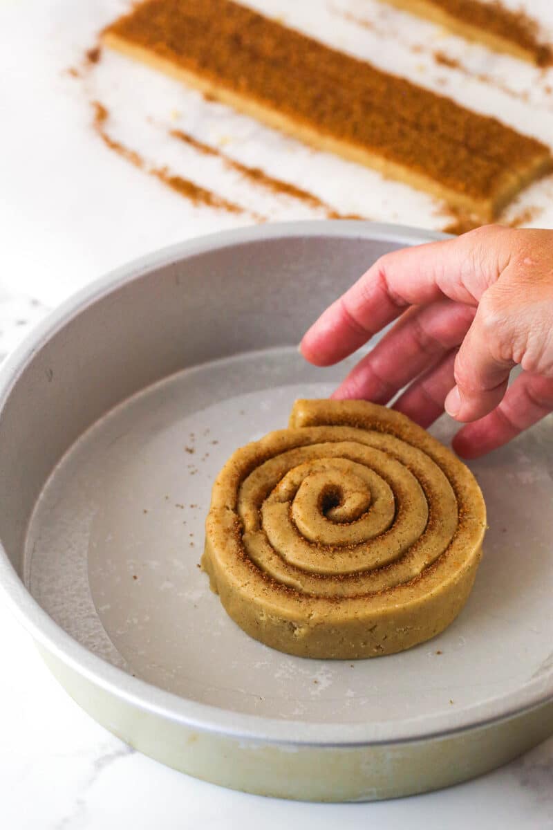 Strips of cookie dough being added to the spiral