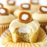 A caramel cream cupcake with a bite missing