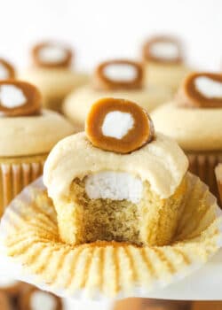 A caramel cream cupcake with a bite missing