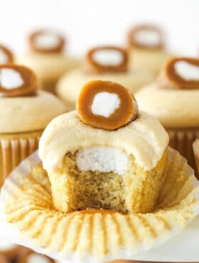 A caramel cream cupcake with a bite missing