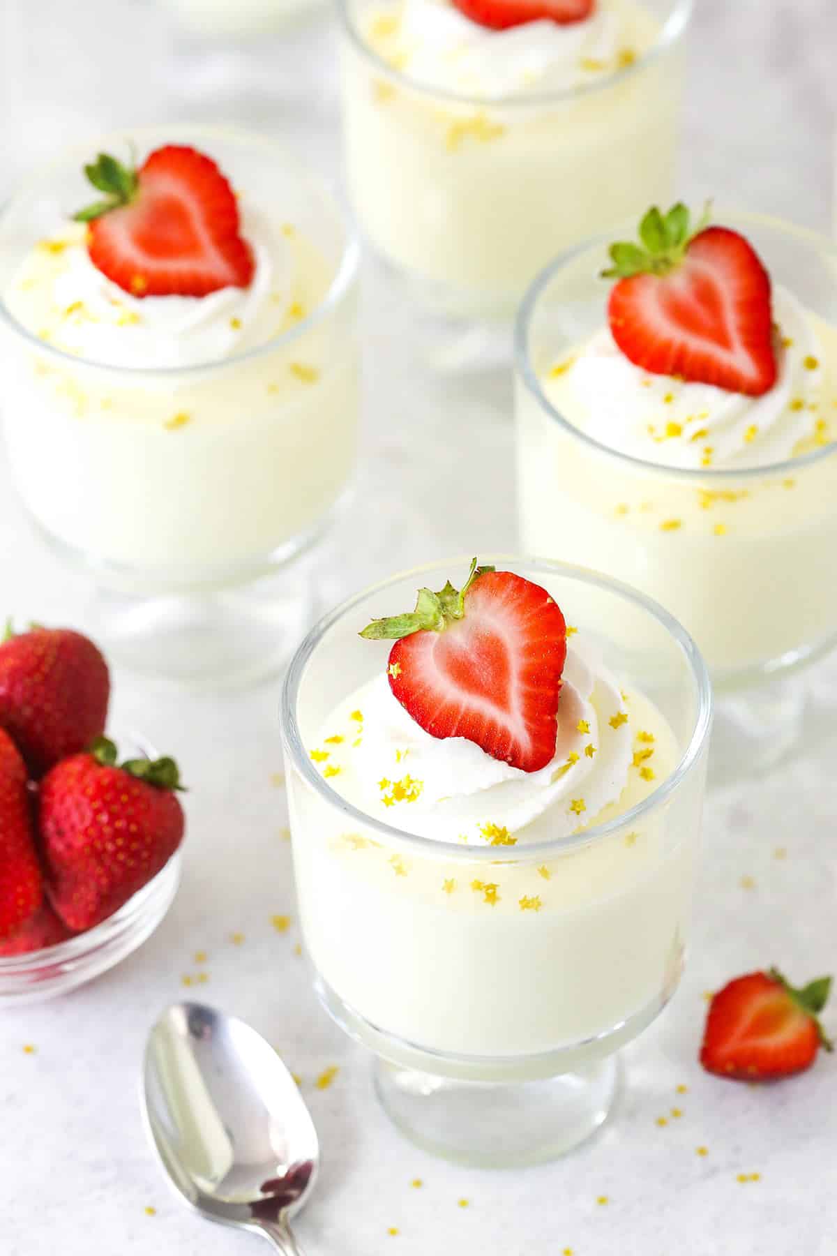 Overhead view of champagne mousse in glass cups with a strawberry