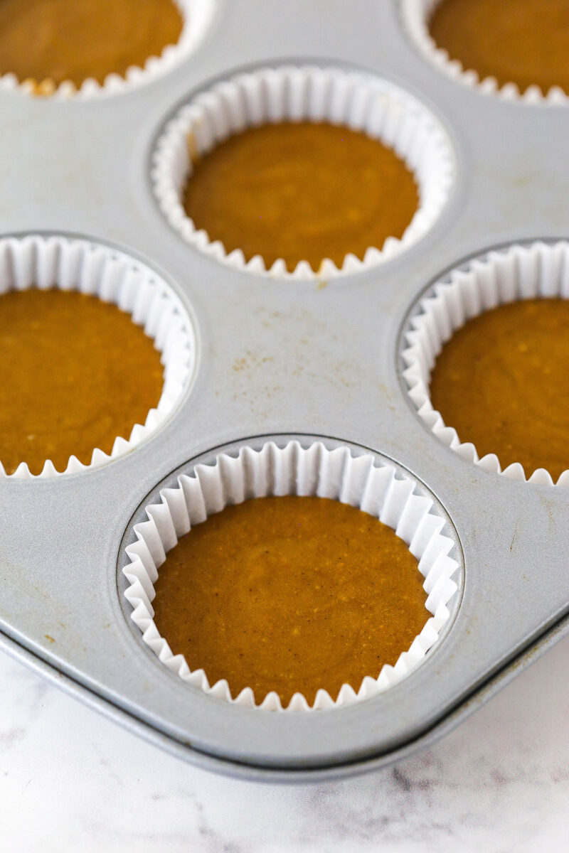 Gingerbread cupcake batter in cupcake liners