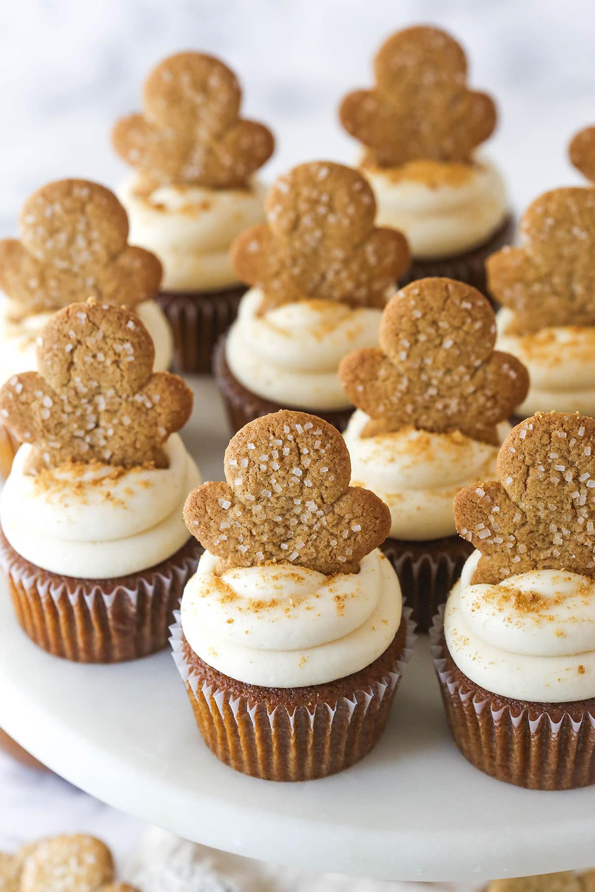 Gingerbread cupcakes topped with caramel frosting and gingerbread cookies