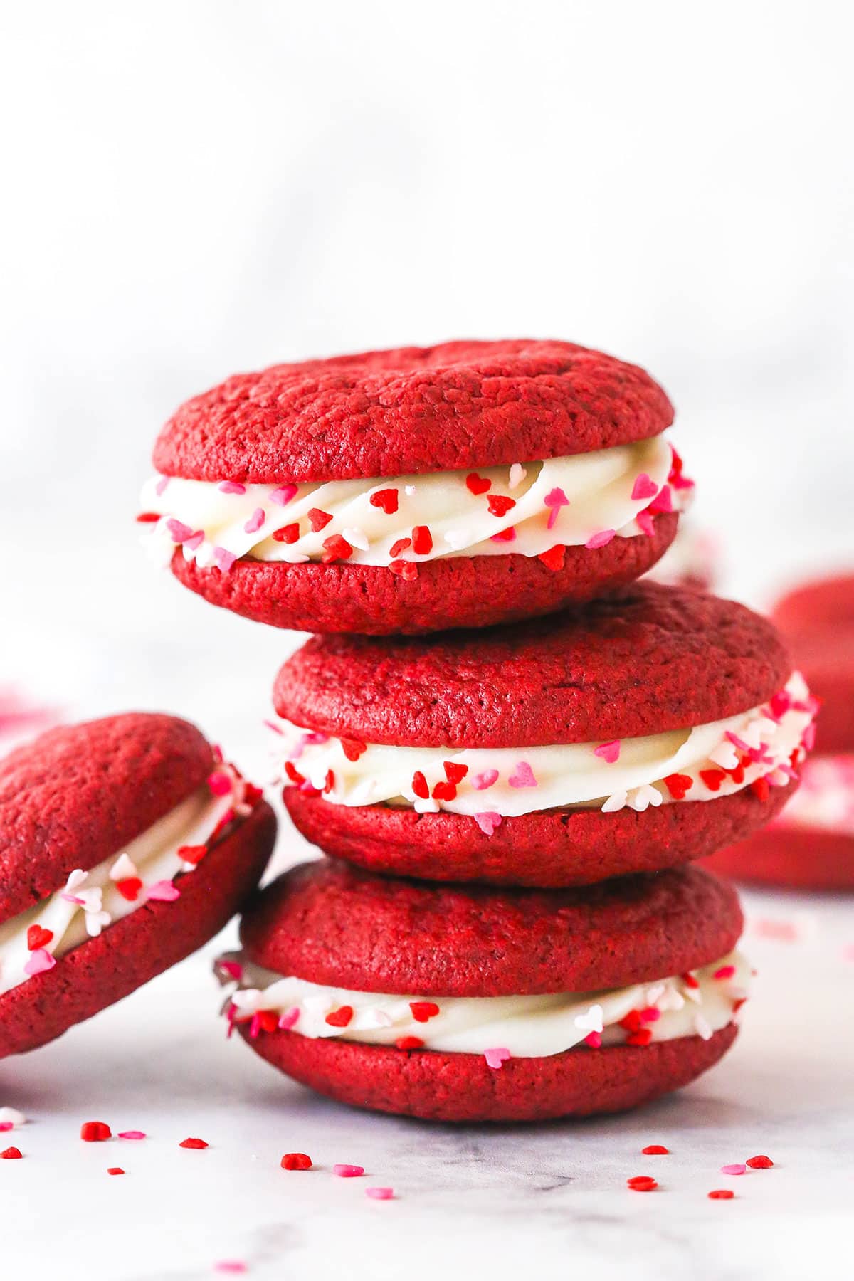 A stack of three red velvet cookie sandwiches