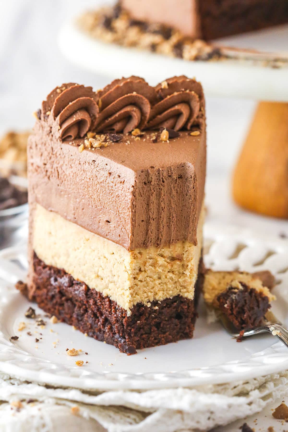 slice of peanut butter chocolate mousse cake with a bite taken out