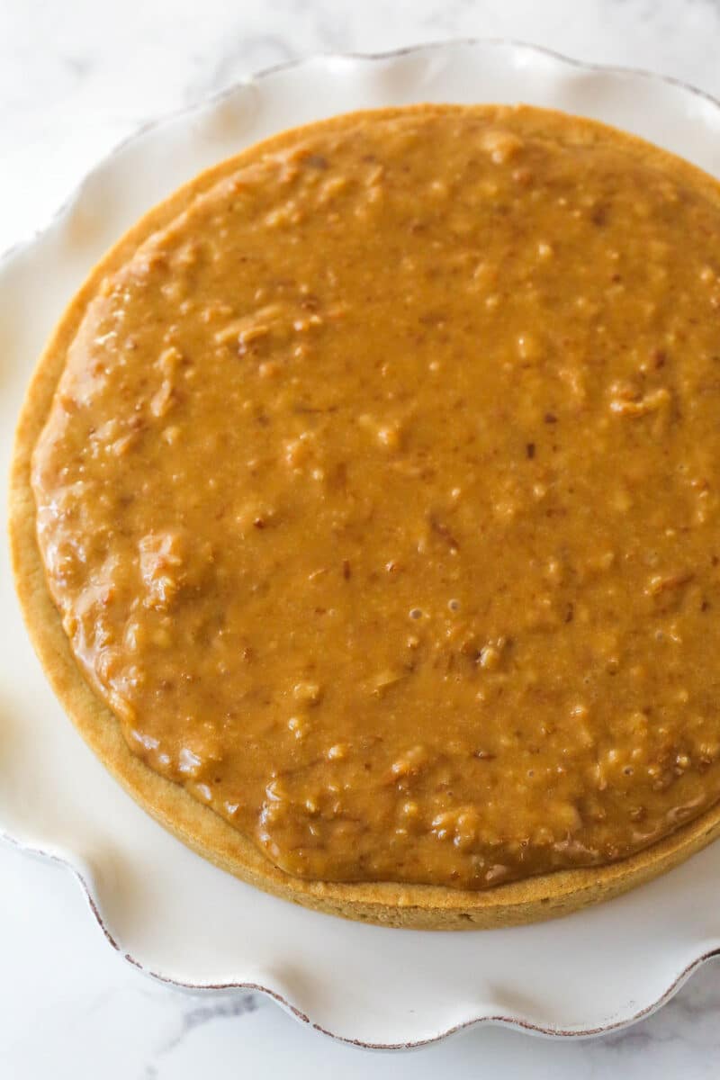 Caramel coconut sauce spread over a sugar cookie cake