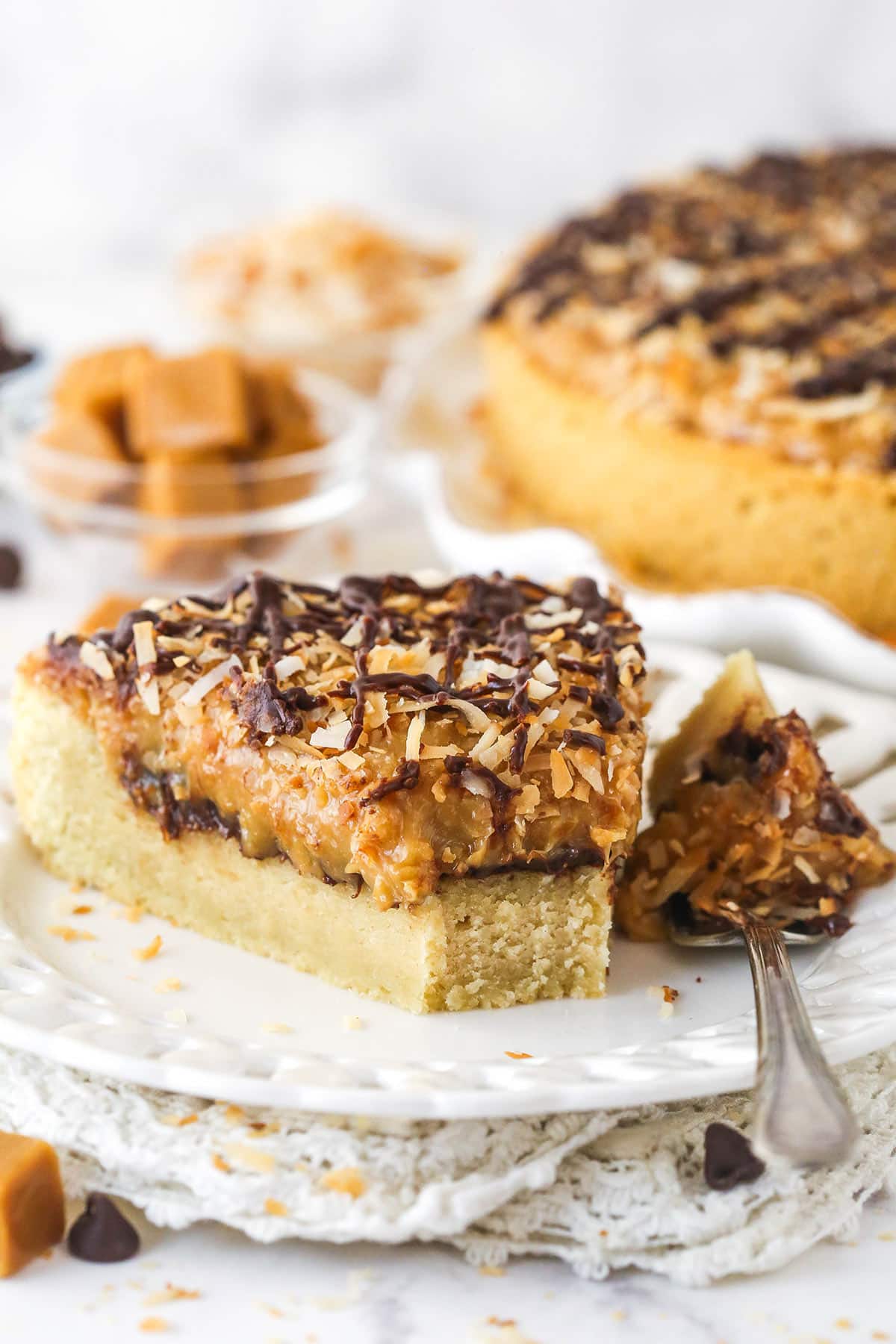 Samoa cookie cake on a white plate with a bite on a fork