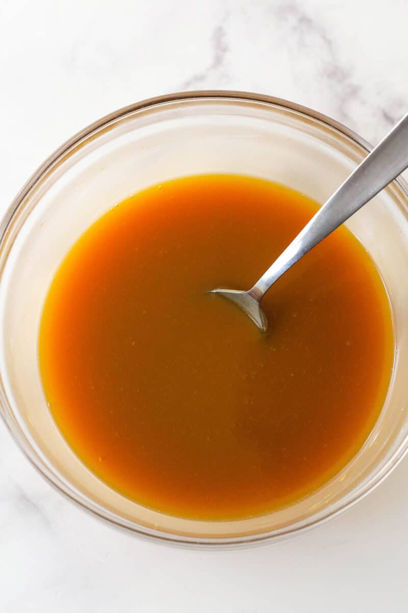 Melted butterscotch chips and heavy cream in a glass bowl