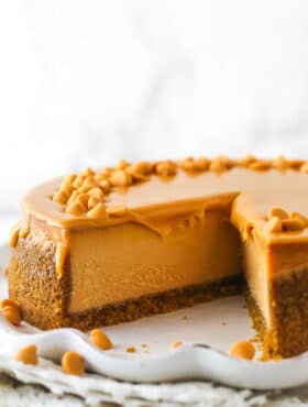 A butterscotch cheesecake with a slice missing