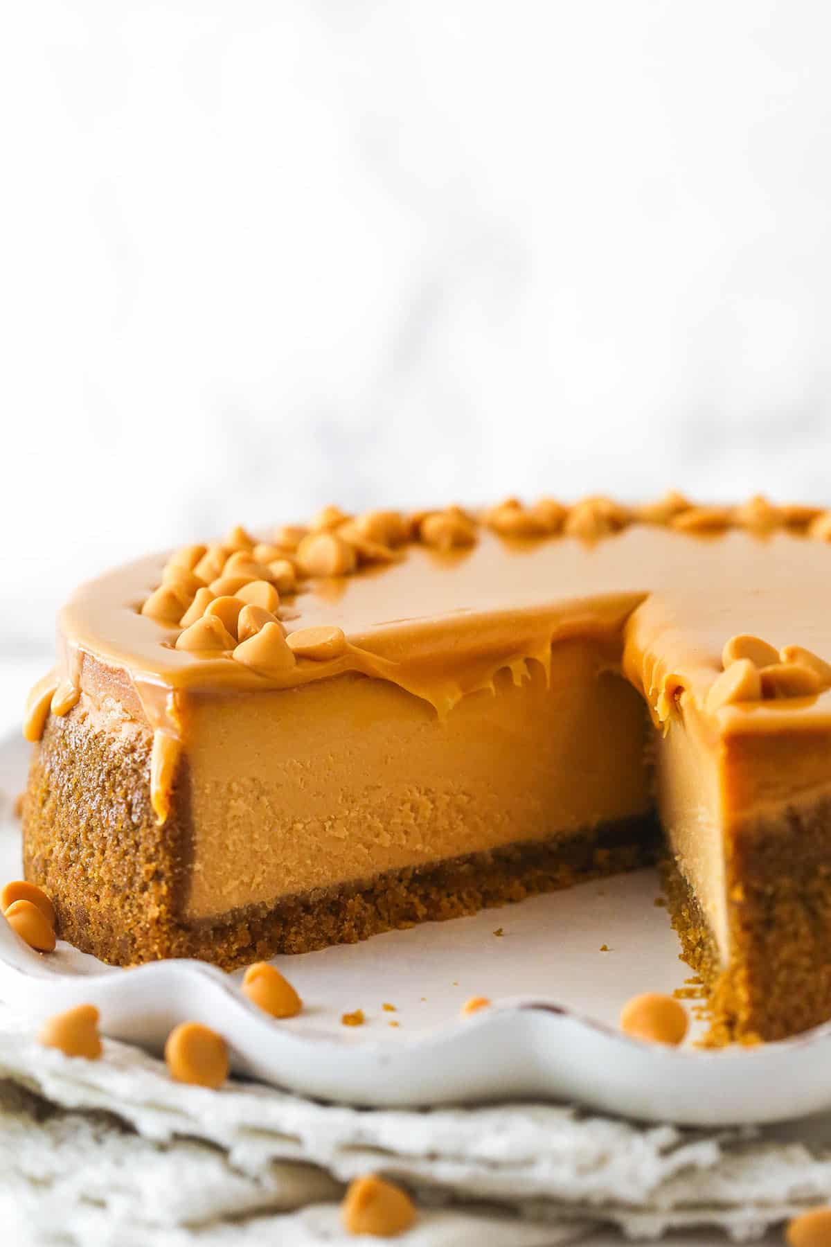 A butterscotch cheesecake with a slice missing