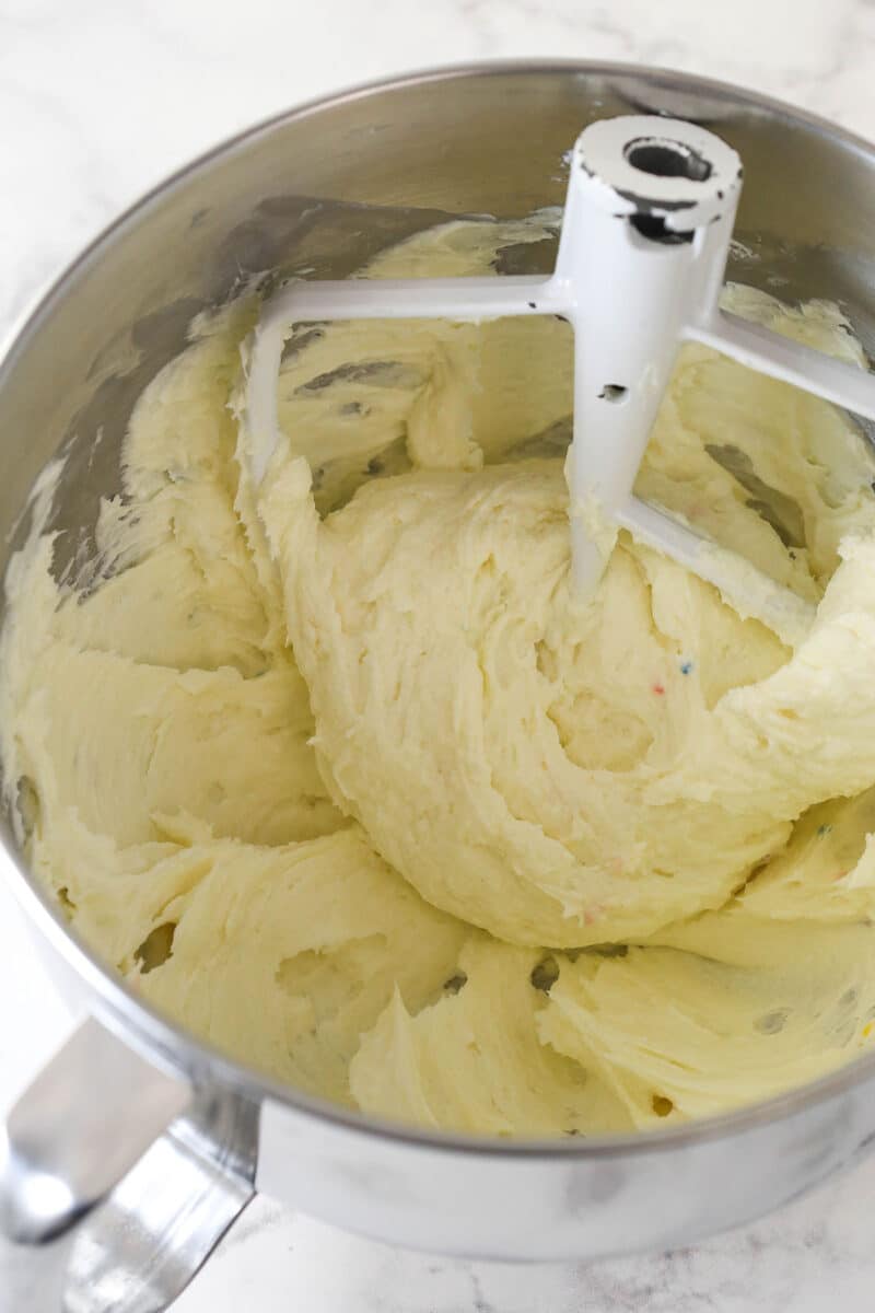 Mixing cream cheese and sugar in a mixing bowl