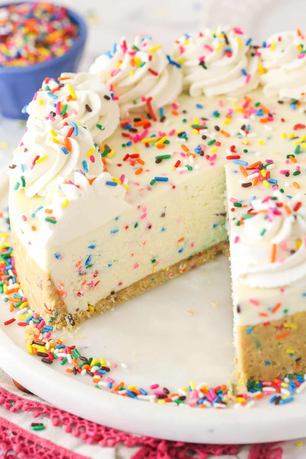 Overhead view of a no bake funfetti cheesecake with a slice missing