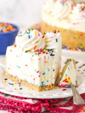 No bake funfetti cheesecake on a plate with a bite on a fork next to it