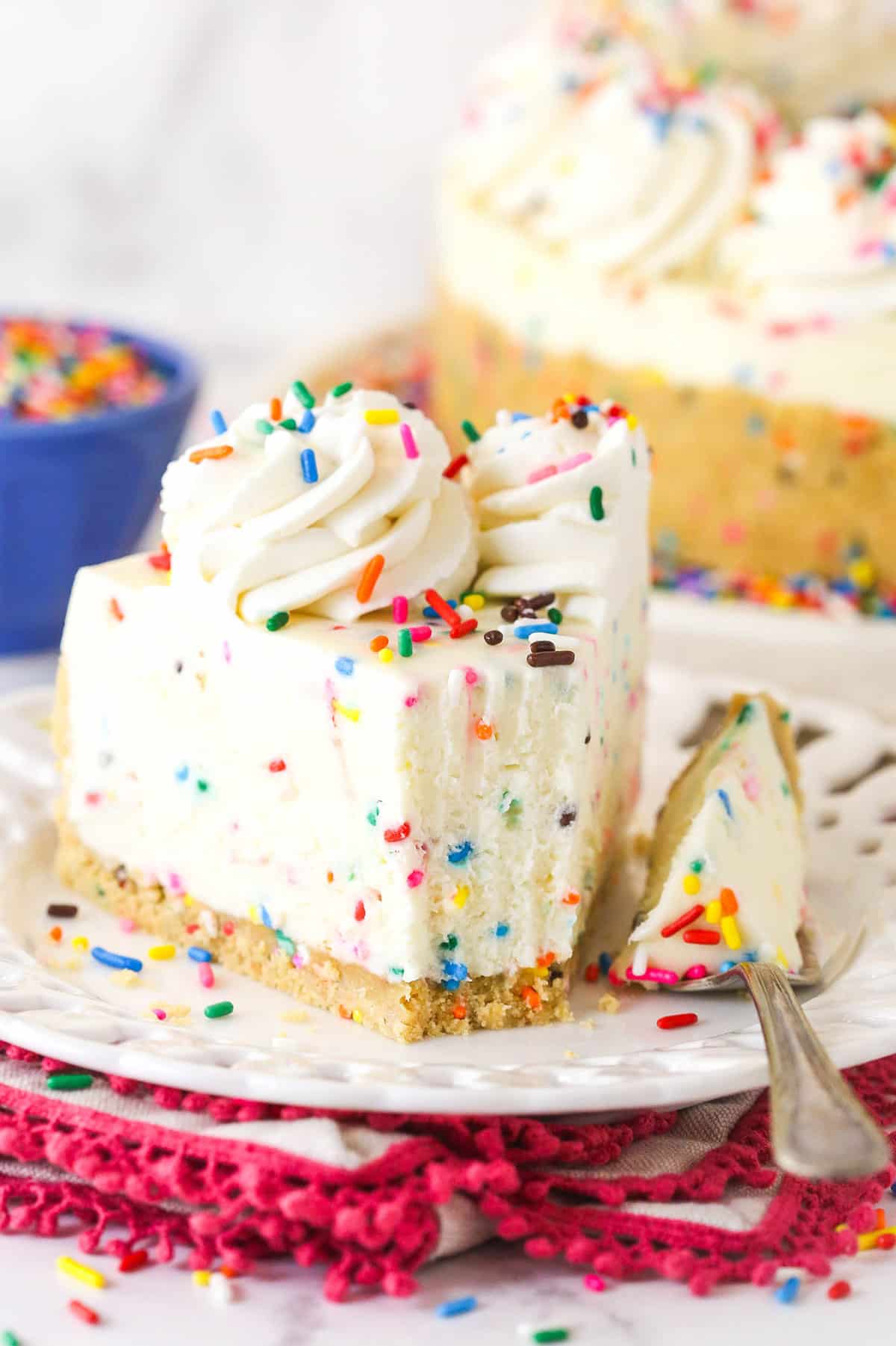 No bake funfetti cheesecake on a plate with a bite on a fork next to it