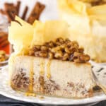 A slice of baklava cheesecake on a white plate