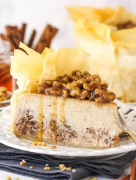 A slice of baklava cheesecake on a white plate