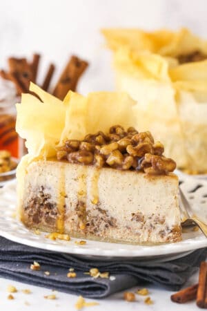 A slice of baklava cheesecake on a white plate