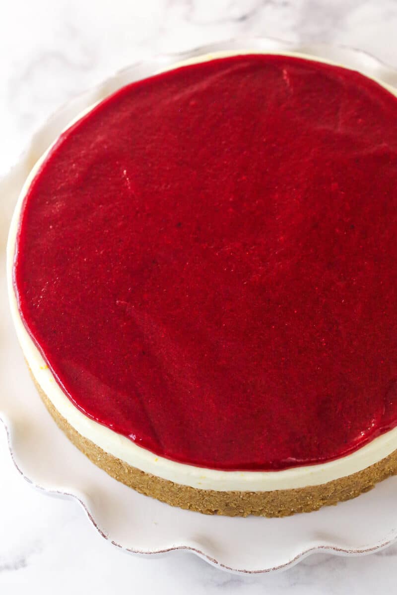 Cranberry sauce spread on top of a cheesecake