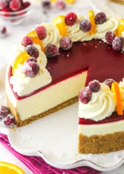 A cranberry orange cheesecake with a slice missing