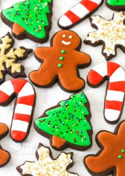 decorated Christmas cutout cookies on a marble countertop