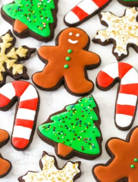 decorated Christmas cutout cookies on a marble countertop