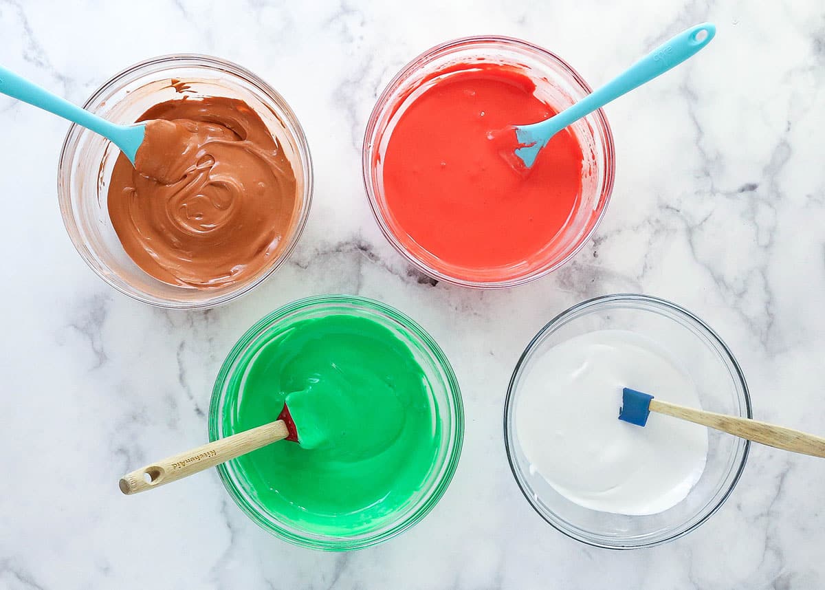 colored royal icing in glass bowls