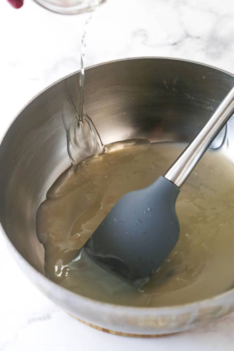 adding the melted gelatin to cooked champagne mixture