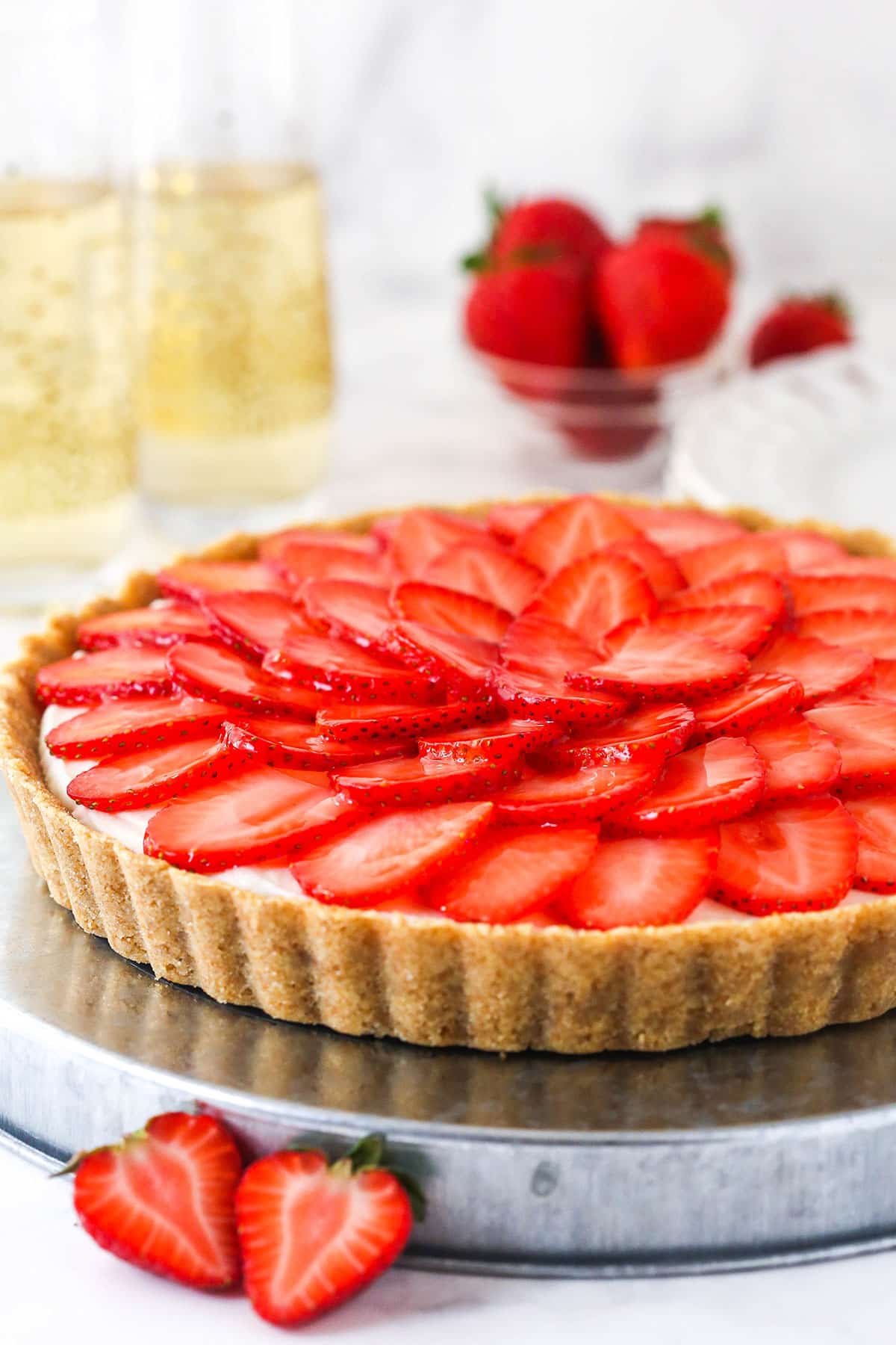 strawberry champagne tart on silver platter