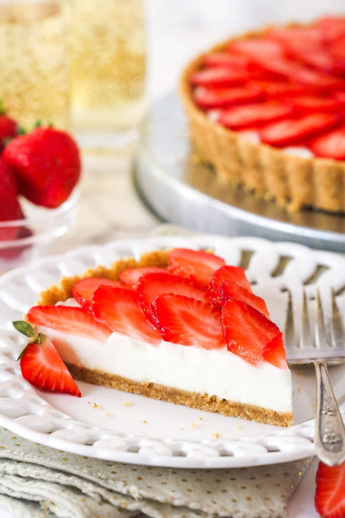 slice of strawberry champagne tart on a white plate