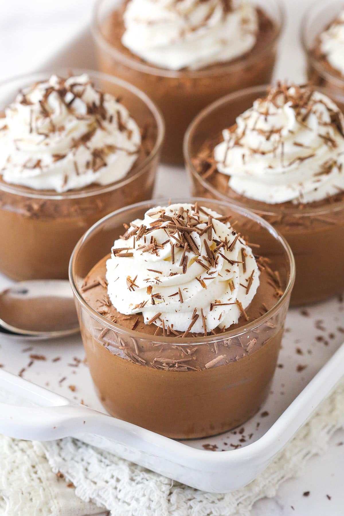 Cups of chocolate mousse topped with whipped cream