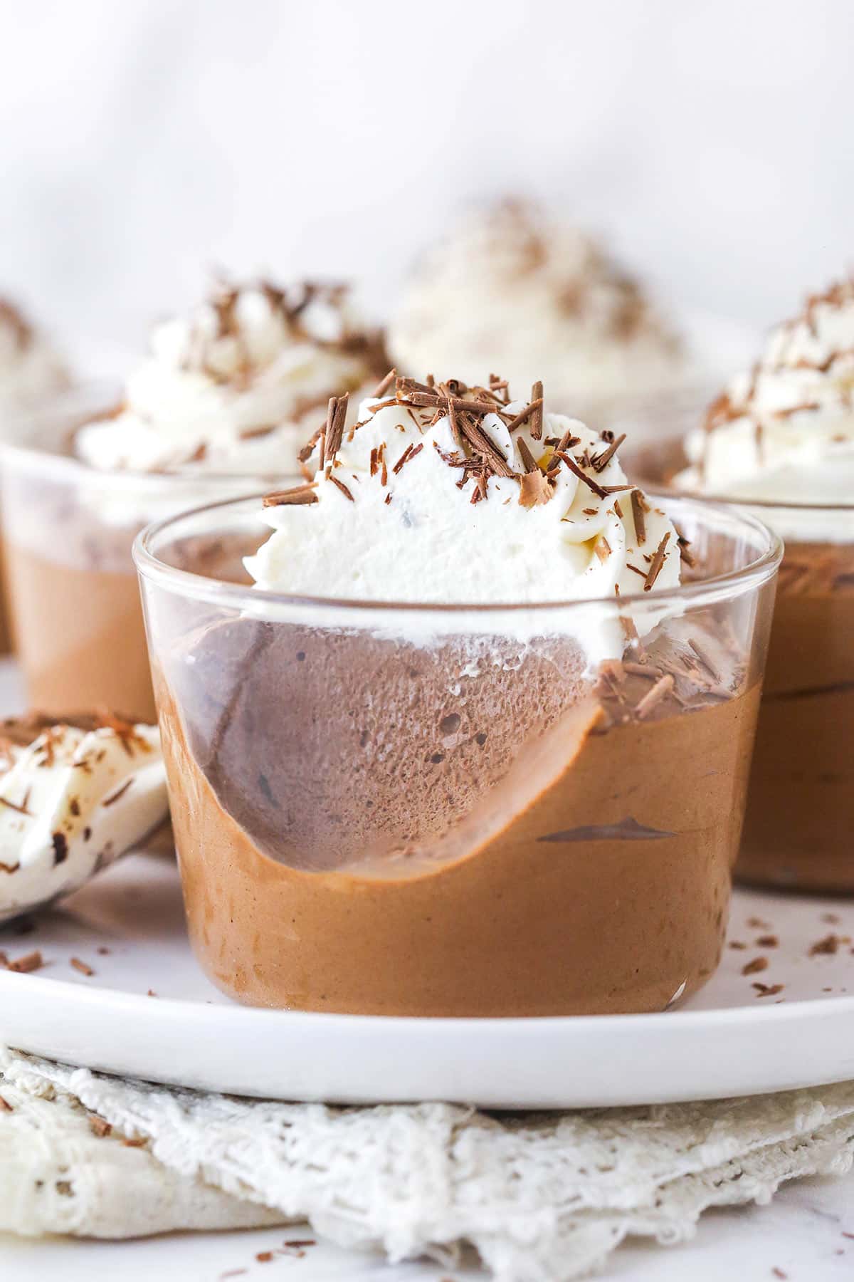 A chocolate mousse cup with a few bites missing