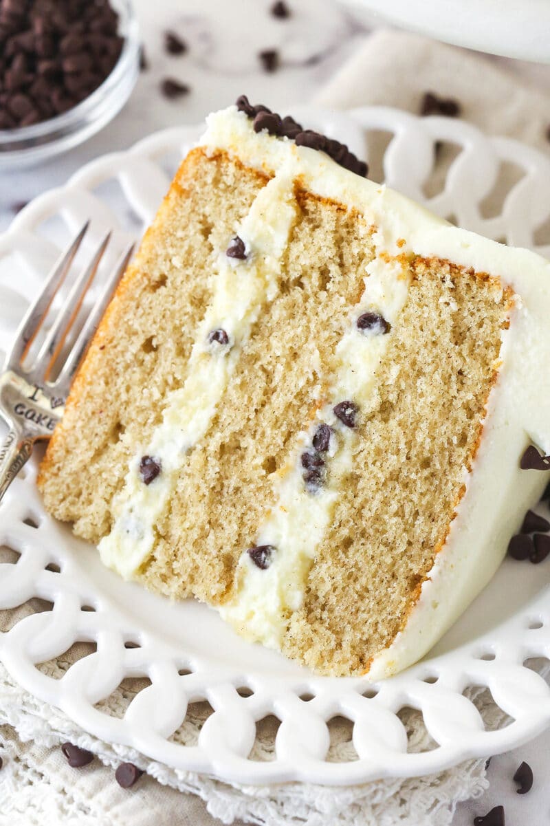 A slice of cannoli layer cake on a white plate