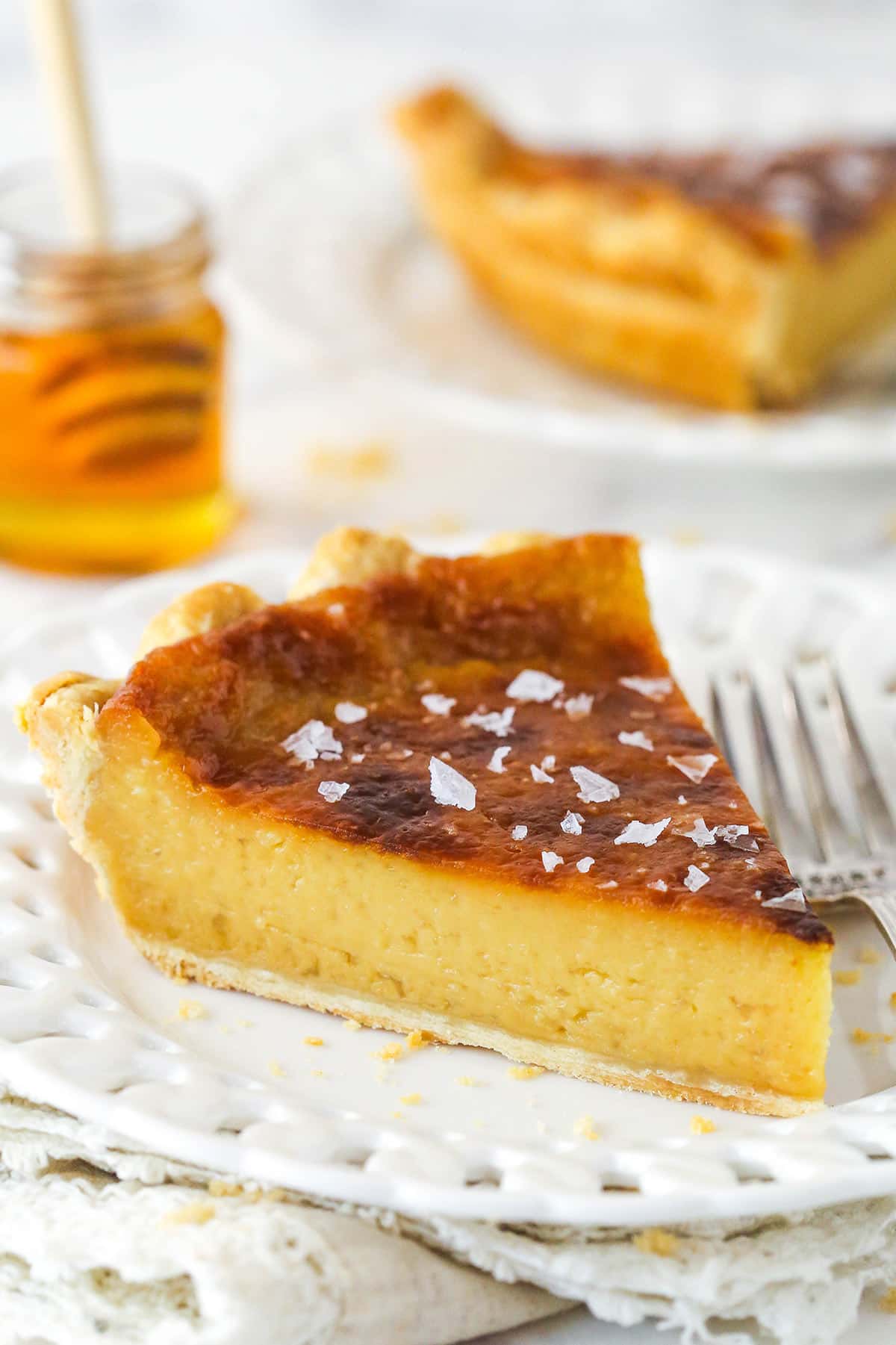 A slice of honey pie on a white plate