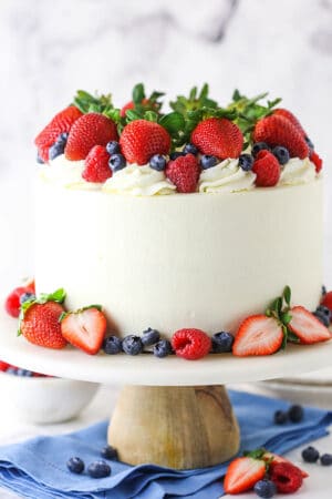 Tray of refreshing summer cakes featuring berry icebox cake, lemon summer cake, and strawberry summer cake with vibrant fruit toppings.