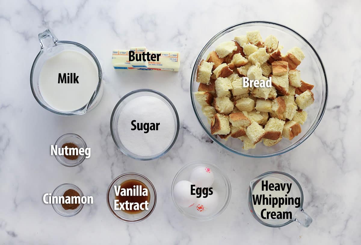 Ingredients for bread pudding on a marble counter.