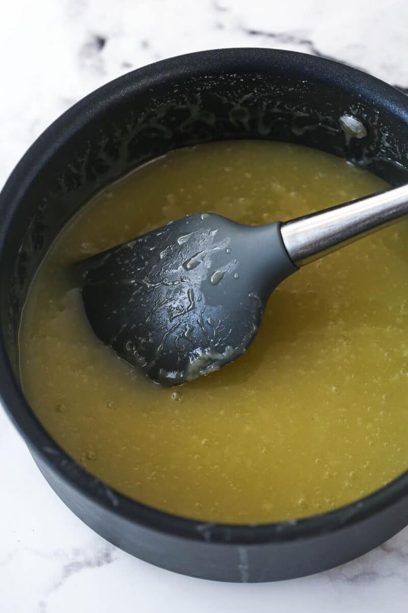 Making sauce to pour over bread pudding in a saucepan.