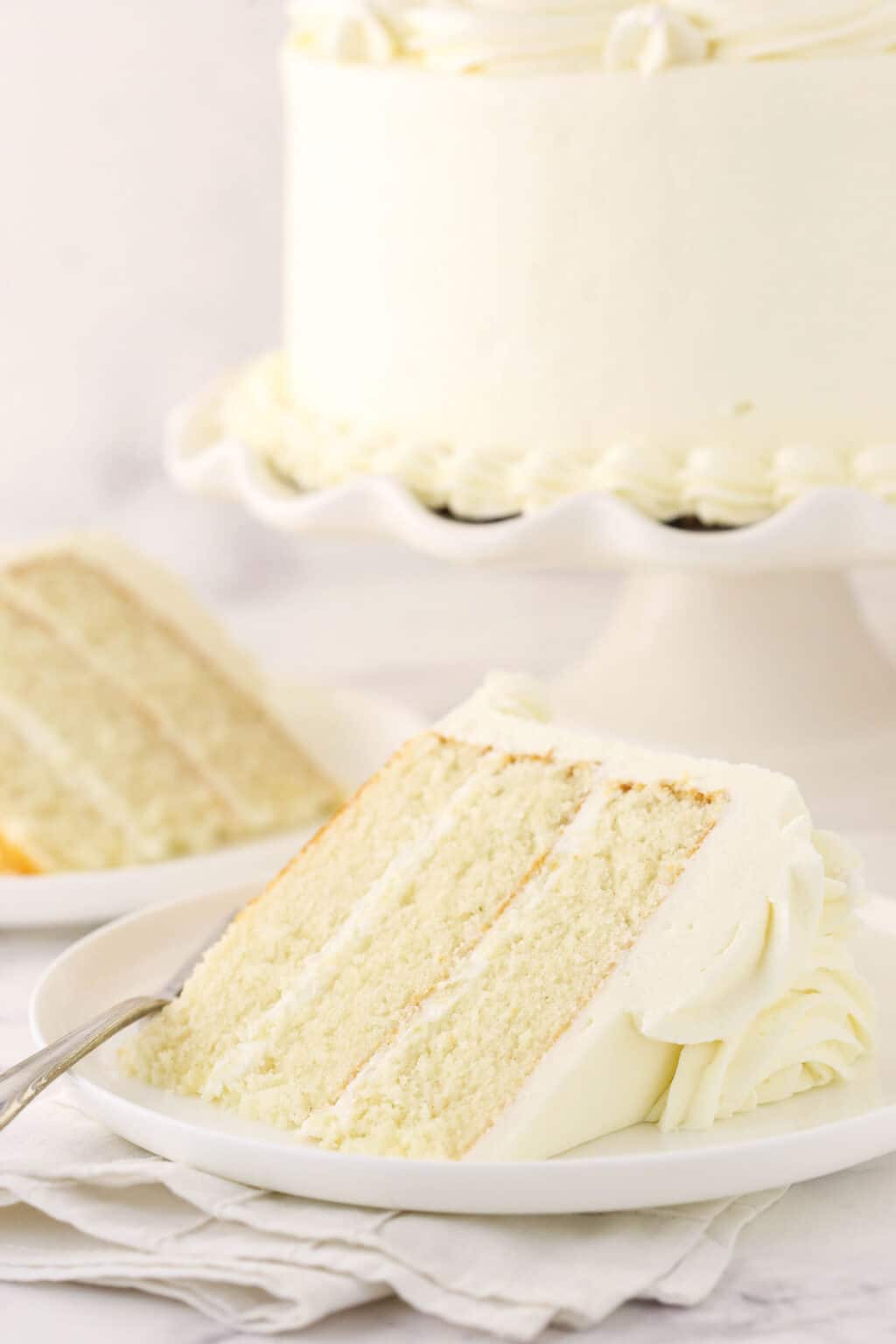 Light and Fluffy White Cake with Whipped Frosting | Life Love & Sugar