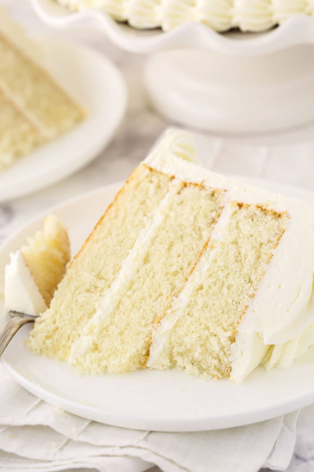 Light and Fluffy White Cake with Whipped Frosting | Life Love & Sugar