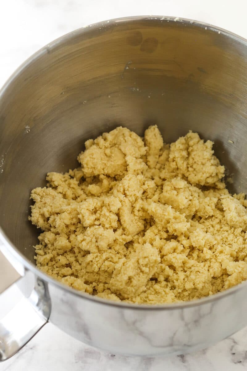 Crumbly almond crescent dough in a mixing bowl.